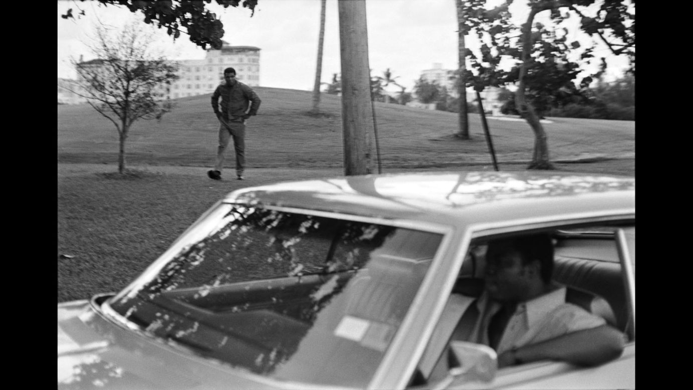 Ali cools down after running at dawn. In the car is Bundini Brown, his longtime friend and cornerman.
