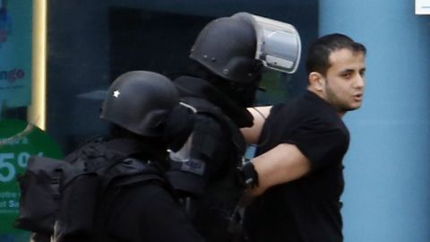 A man who had taken hostages in a post office surrenders to French officers. 
