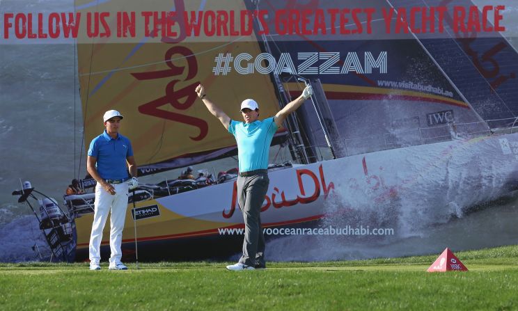 McIlroy celebrates his ace with playing partner Rickie Fowler in the background. Fowler fell away to a second round 75 to be right on the cut line at two-under-par.