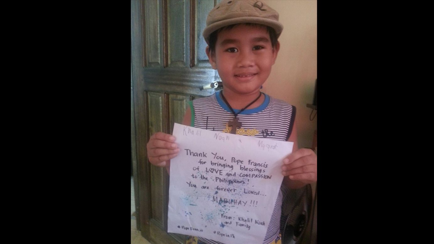 "Gee Eecchh Kyu" and her family will be attending the Pope's mass in Manila. Her son, 5-year-old Khalil Noah Macarat, holds the sign in the picture. "We are so happy and blessed (that) he chose the Philippines for his visit!" says "Gee Eecchh Kyu."