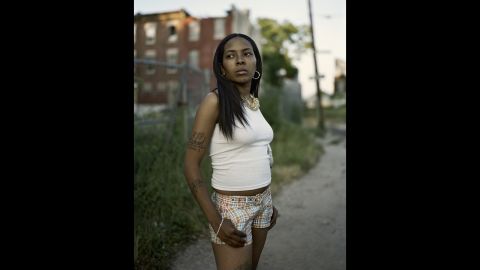 A woman from North Philadelphia stands at 23rd Street and West Montgomery Avenue in 2008. Photographer Daniel Troub's new book, "North Philadelphia," profiles a struggling area that he says is ripe with beauty and possibility.