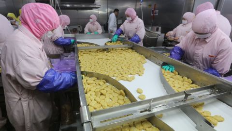Workers producing food at a factory in Shanghai. 