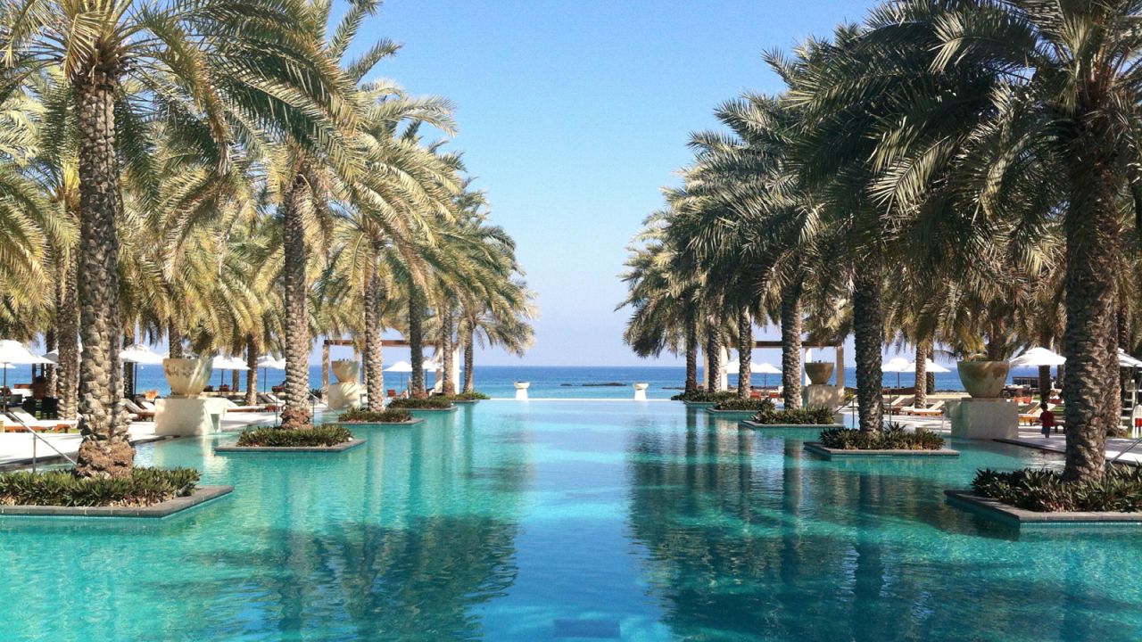 La piscina infinita de 50 metros y con temperatura controlada está rodeada de palmeras y se extiende hacia la playa privada. 