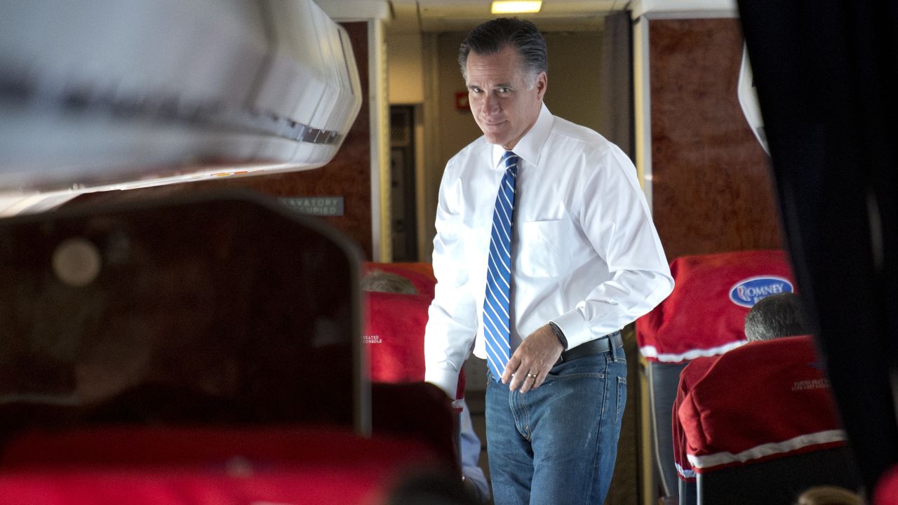 US Republican Presidential candidate Mitt Romney walks aboard his campaign plane while flying from Norfolk, Virginia, to Milwaukee, Wisconsin, on November 2, 2012.