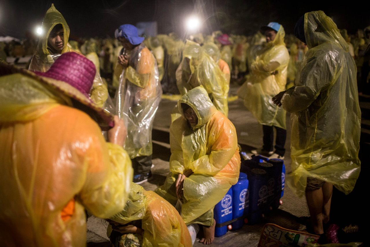 Pilgrims sit through heavy rain and high winds as they wait for the arrival of Pope Francis at Tacloban Airport on January 17.
