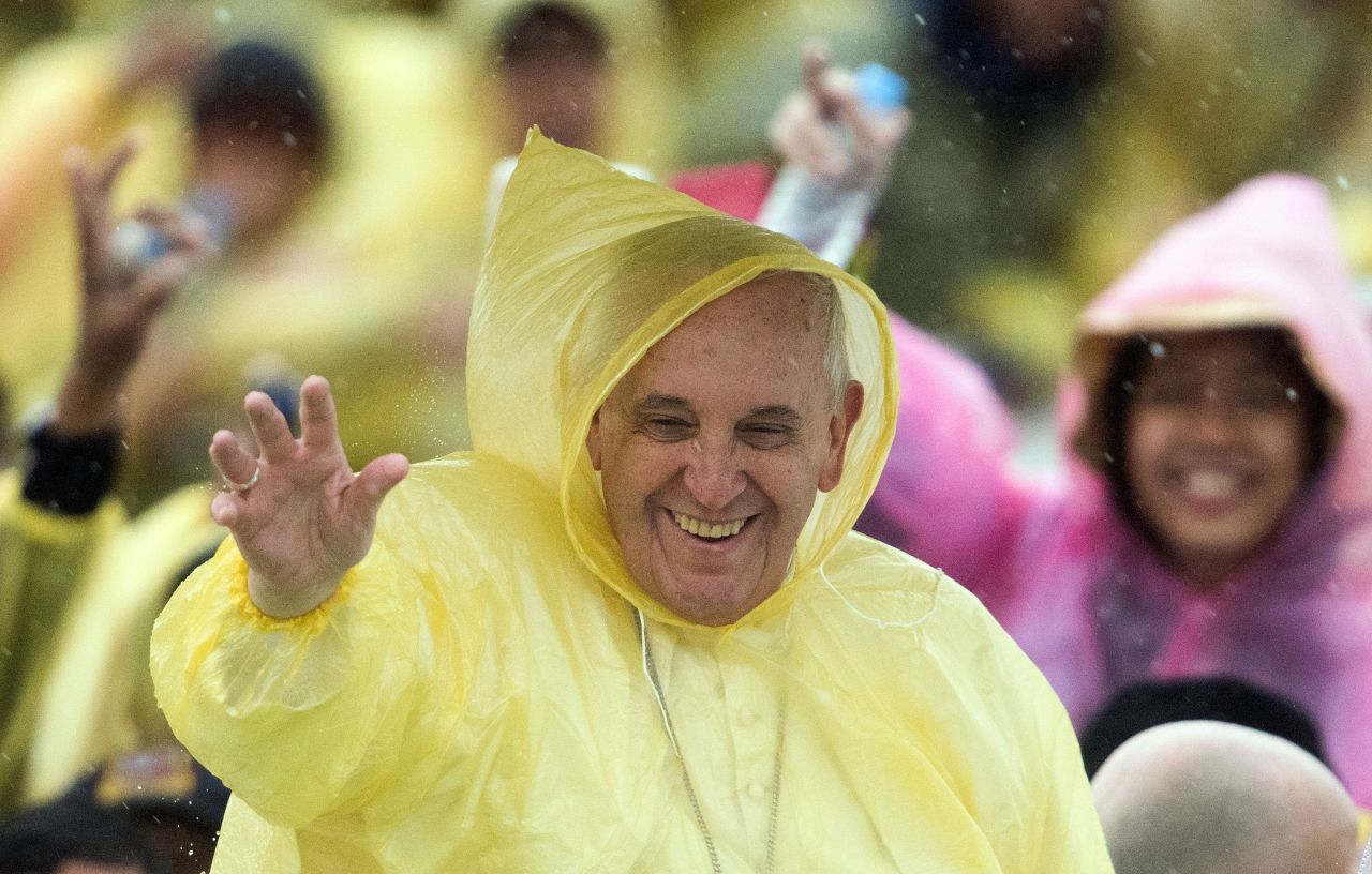 Pope Francis, wearing a plastic poncho, waves to well-wishers after Mass in Tacloban, Philippines, on Saturday, January 17. The Mass was shortened because of an approaching typhoon bearing 75-mph winds and heavy rain. 