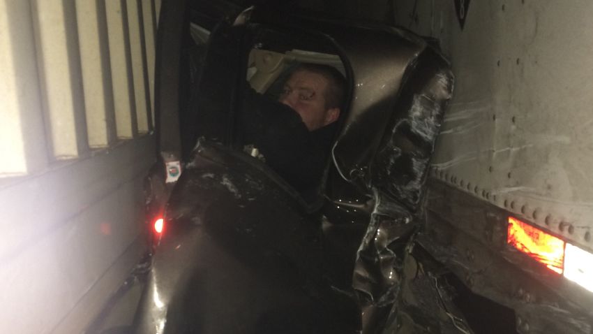 Kaleb Whitby, 27, is wedged in what's left of his pickup after a pileup crash sandwiched him between 2 semi trucks.