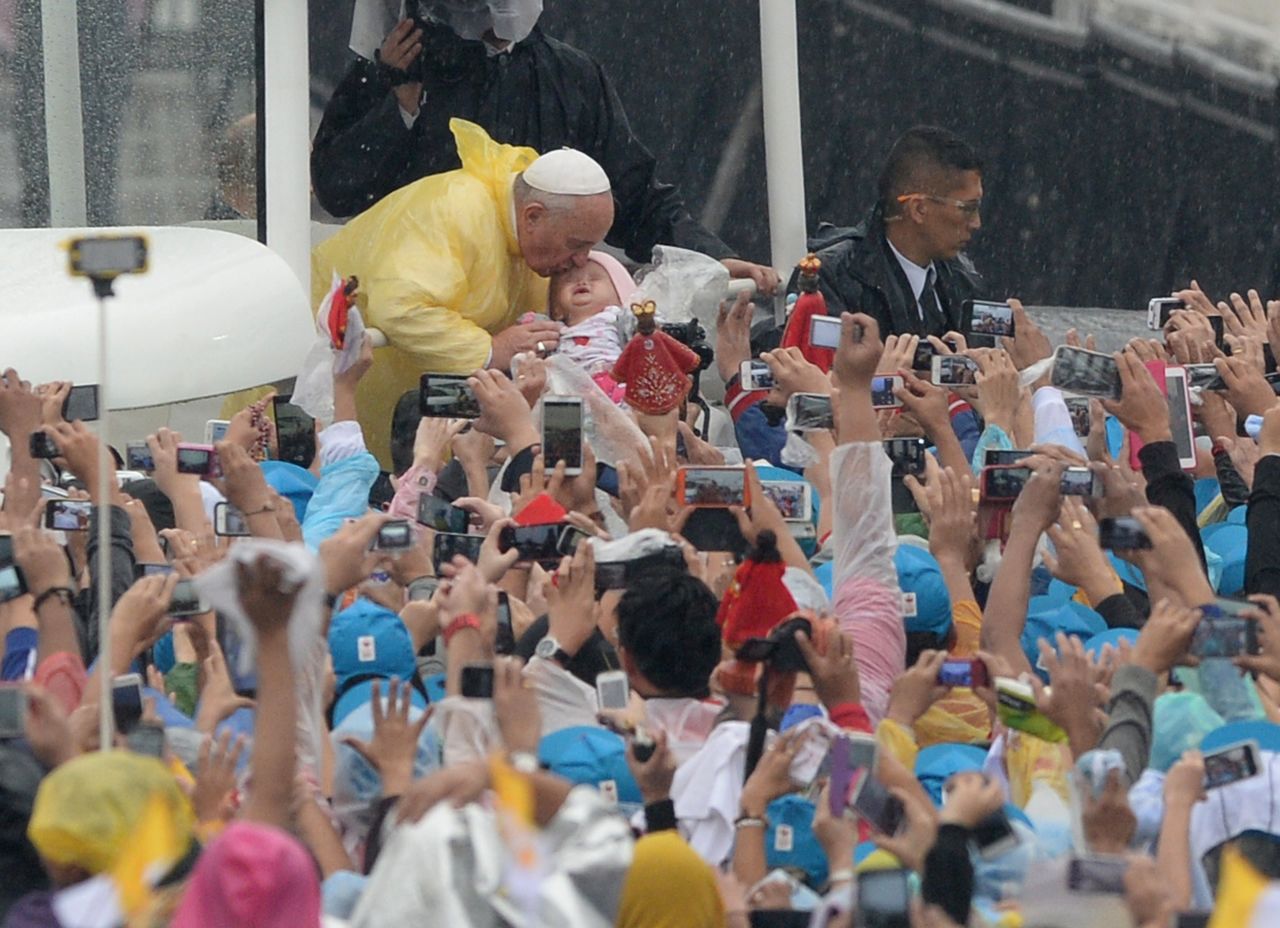 Pope Francis kisses a child on January 18 in Manila. 