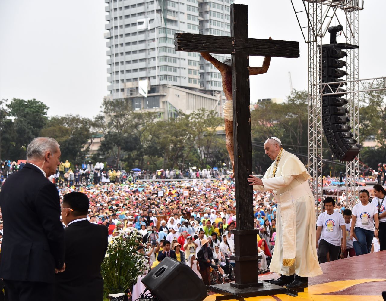 The Pope prays in front of a cross during his visit to the University of Santo Tomas in Manila on January 18. 