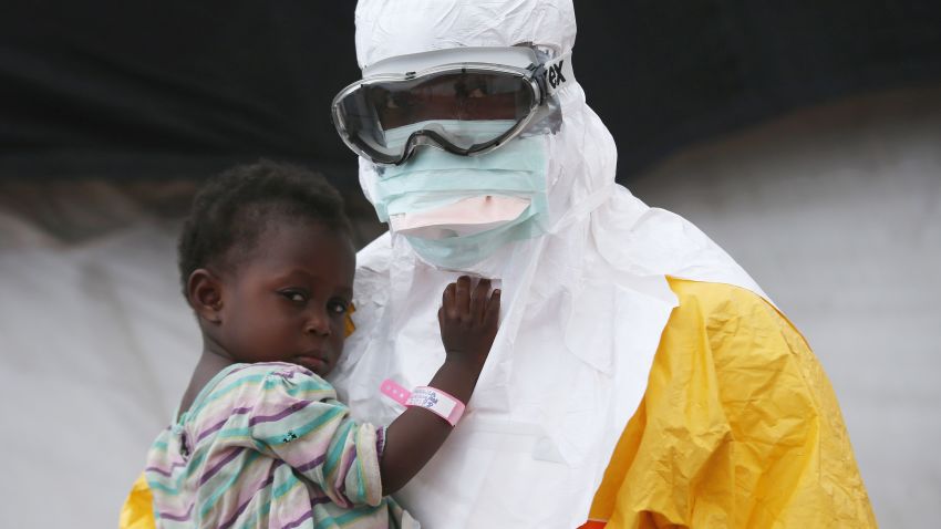 A Doctors Without Borders worker holds a child suspected of having Ebola in a treatment center in Liberia in October 2014.