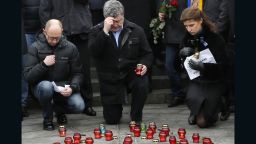 Ukrainian President Petro Poroshenko, center, his wife Maria,right, and Ukrainian Prime Minister Arseniy Yatsenyuk, pay their respects during a rally on Sunday, January 18 at Independence Square in Kiev, Ukraine.  The rally was to show solidarity with the victims of a rocket  that claimed 13 lives on a highway near the town of Volnovakha.