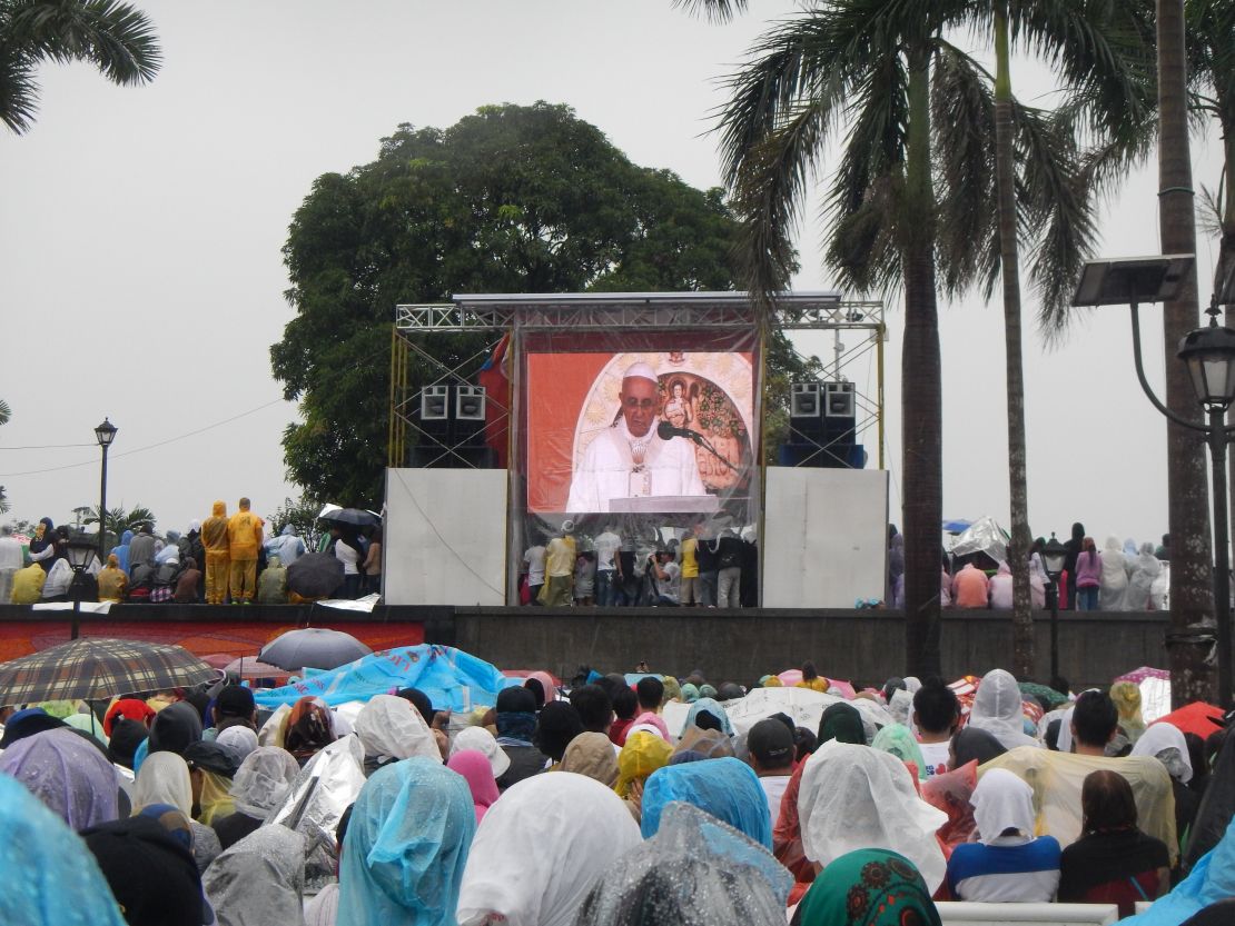The faithful bow their heads and listen to the words of the man many call the "Vicar of Christ."