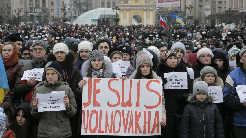People hold sign that reads: 'I am Volnovakha' during a rally on Independence Square in Kiev, Ukraine, in solidarity with the victims of a rocket attack this week that claimed 13 lives on a highway near the eastern town of Volnovakha, on Sunday, Jan. 18, 2015. Ukraine's government accuses Russian-backed separatists of launching the rocket attack, which hit a passenger bus, but the rebels have rejected that charge. (AP Photo/Efrem Lukatsky)