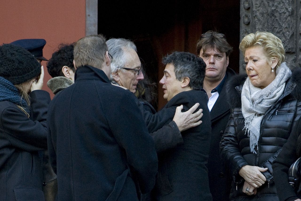 Gerard Gaillard, one of the survivors of the Charlie Hebdo attack, and Patrick Pelloux, doctor and Charlie Hebdo contributor, comfort each other during the funeral of Michel Renaud on Wednesday, January 14. Renaud was the former chief of staff for the mayor of Clermont-Ferrand, France.