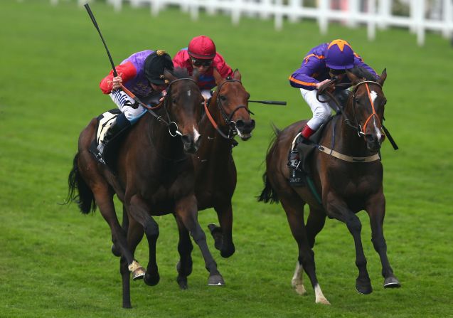 Moore (left) has regularly ridden in the Queen's colors such as here en route to winning The Gold Cup at Royal Ascot on board Estimate.