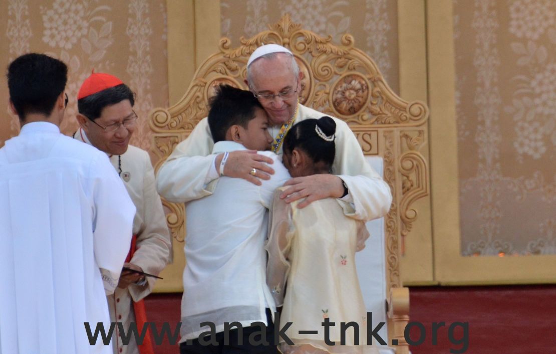 Pope Francis hugging two former street children at a ceremony in Manila, Philippines, on Sunday.
