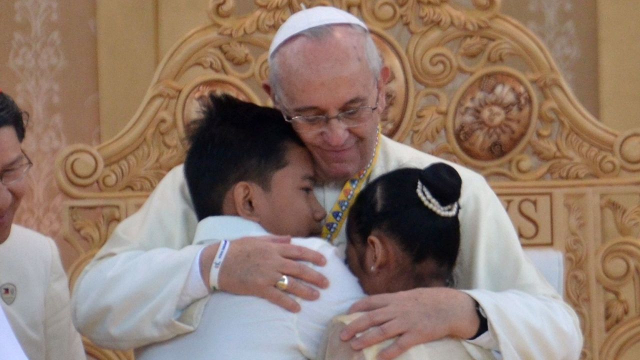 Pope Francis hugging two former street children at a ceremony in Manila, Philippines, on Sunday.