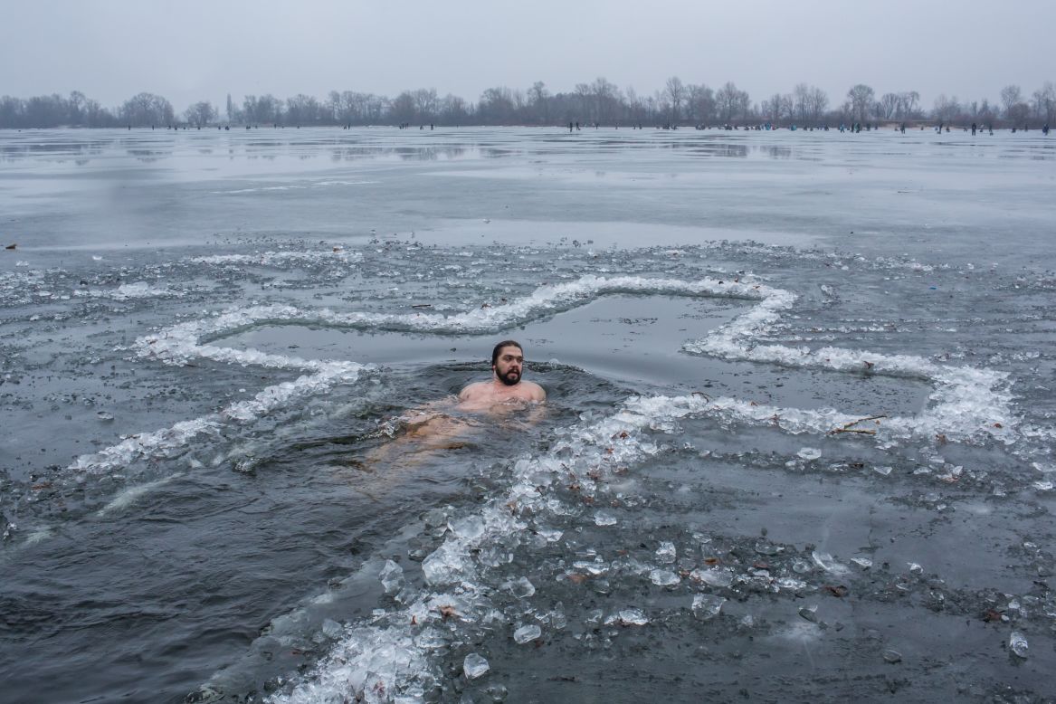 JANUARY 19 - KIEV, UKRAINE: A man bathes in the Dnieper River to mark Epiphany. Orthodox Christians celebrate the baptism of Jesus by plunging into the icy water to symbolically wash away their sins on a day when they believe all water becomes holy.