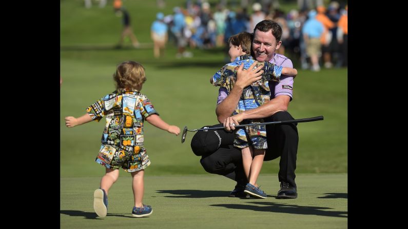 After winning the Sony Open, pro golfer Jimmy Walker celebrates with his sons, Mclain and Beckett, on Sunday, January 18. It was the second straight year that Walker won the event, which is held at Waialae Country Club in Honolulu.