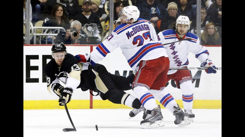 New York Rangers defenseman Ryan McDonagh checks Pittsburgh's Nick Spaling during an NHL game played in Pittsburgh on Sunday, January 18.