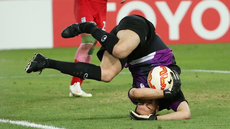 Iran goalkeeper Alireza Haghighi rolls on the ground after securing the ball during an Asian Cup match against Qatar on Thursday, January 15. Iran advanced to the quarterfinals of the tournament with a 1-0 victory.