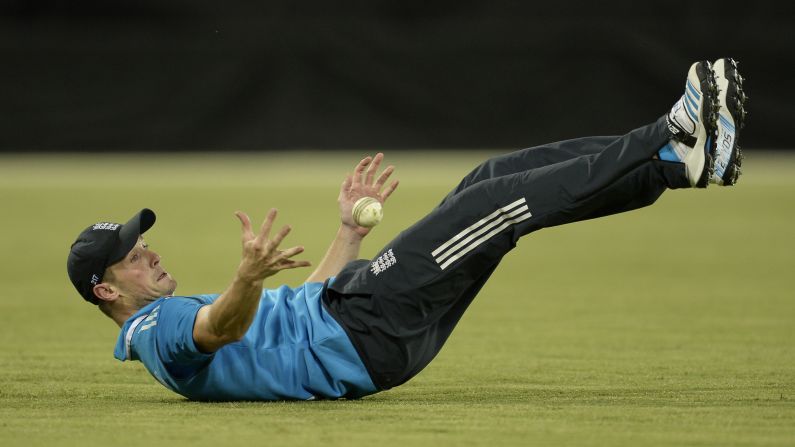 English cricket player Chris Woakes juggles the ball off his feet as he makes a catch Wednesday, January 14, during a match between England and the Prime Minister's XI in Canberra, Australia.