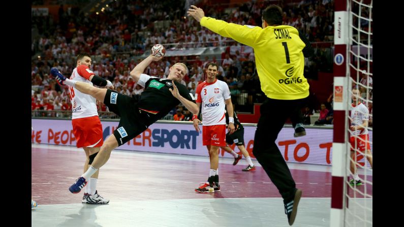 Patrick Wiencek of Germany scores a goal against Slawomir Szmal of Poland at the World Handball Championship on Friday, January 16. The tournament is taking place in Qatar.