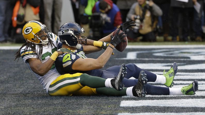 With Green Bay's Tramon Williams wrapped around him, Seattle wide receiver Jermaine Kearse holds on to the touchdown pass that won the NFC Championship on Sunday, January 18.