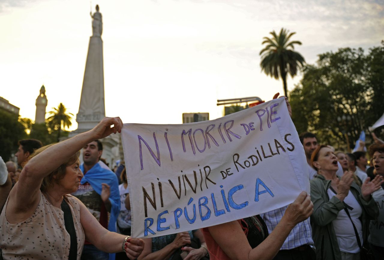 "Ni morir de pie, ni vivir de rodillas. República", dice uno de los carteles de los manifestantes por la muerte del fiscal Nisman. 