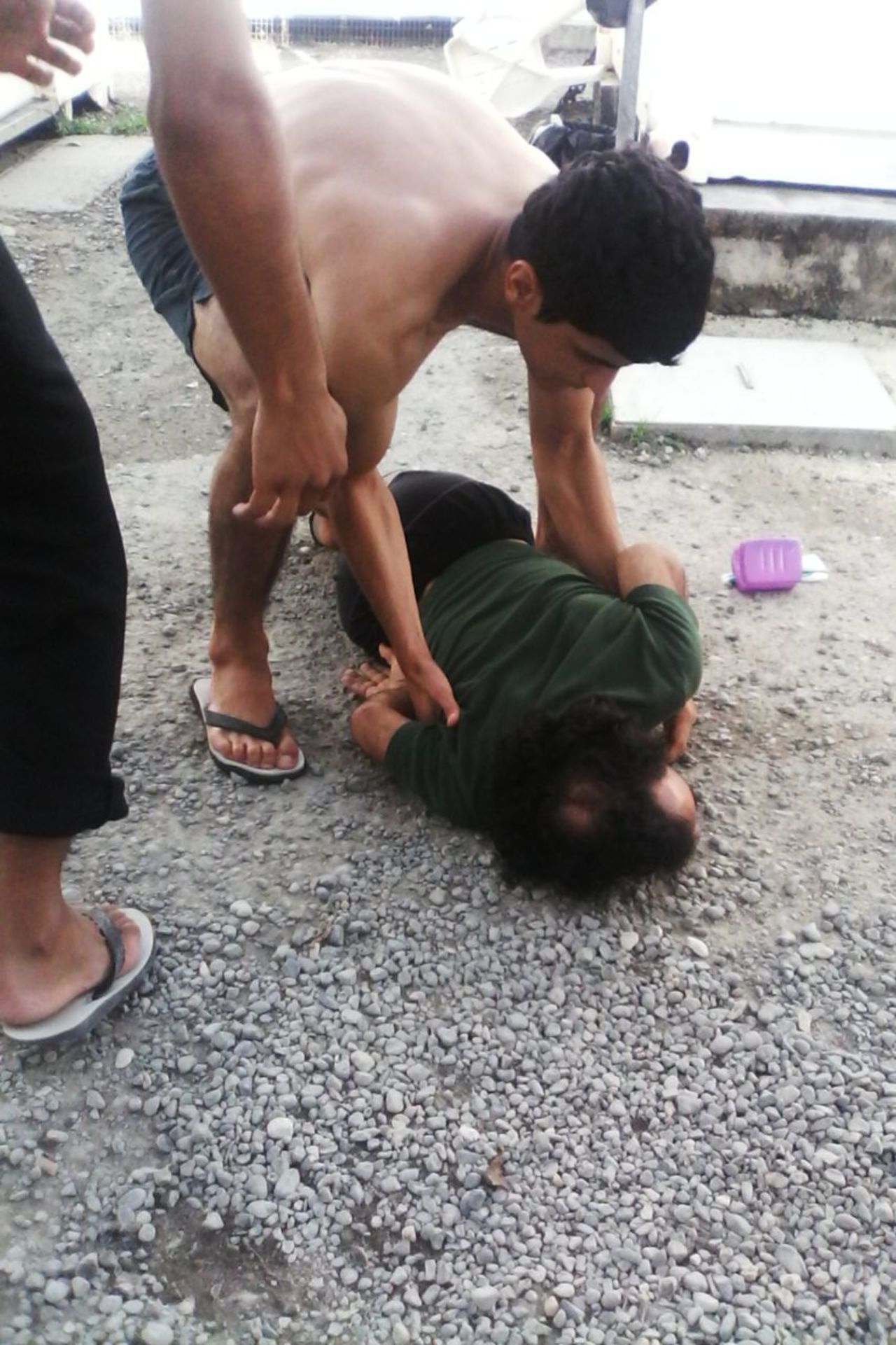 An image sent from a transferee to CNN, taken on Tuesday, February 20, showing a hunger striker who he said had collapsed on the ground.