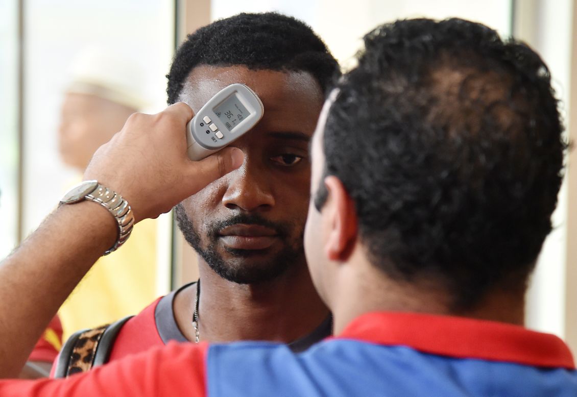 Concerns about the spread of Ebola means the Africa Cup players are tested when they land in Equatorial Guinea. Here Cameroon's defender Nicolas Nkoulou, who plays for Marseille, has his body temperature checked by a health worker at the airport. 