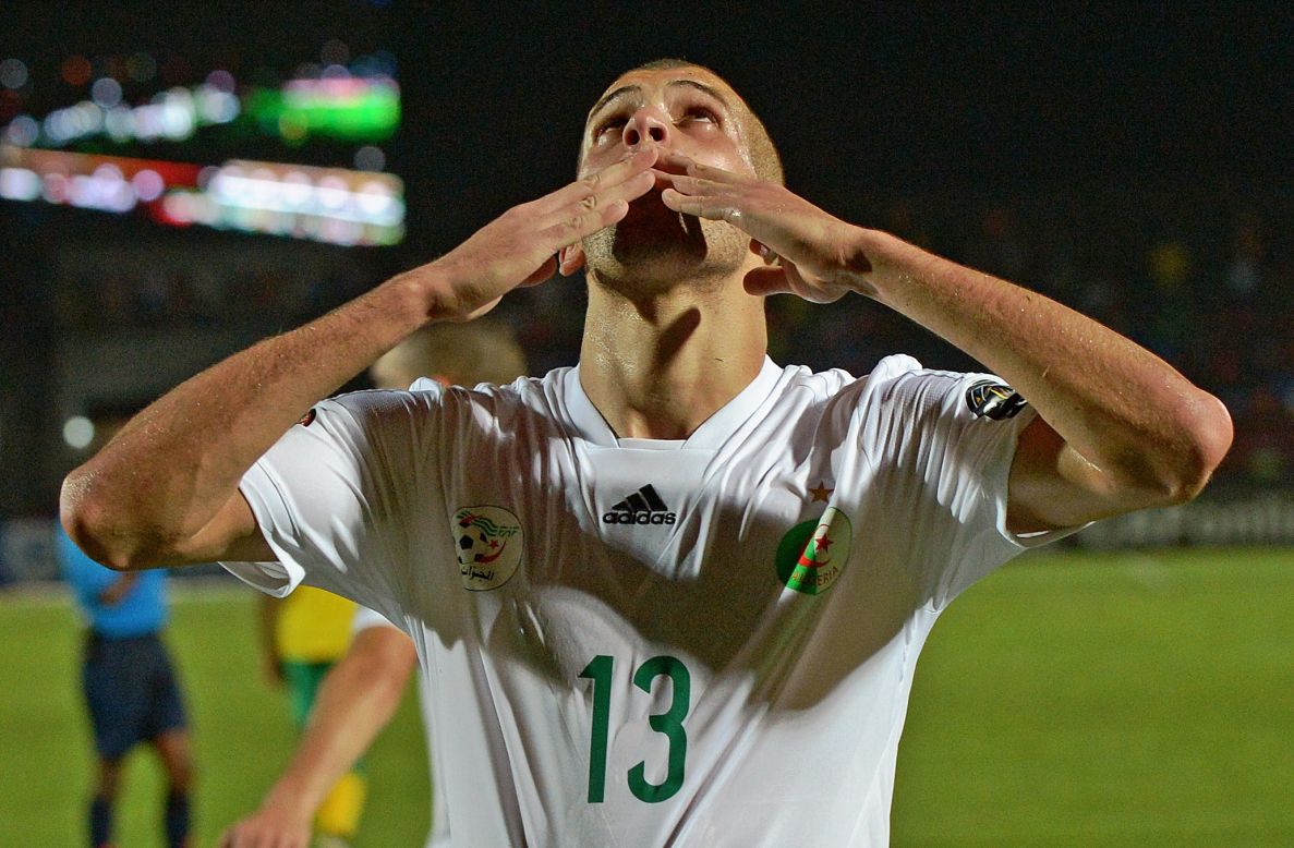 Title favorite Algeria defeats South Africa 3-1 in its first Group C game. Striker Islam Slimani celebrates scoring the third goal. Algeria reached the knockout stages of the 2014 World Cup.