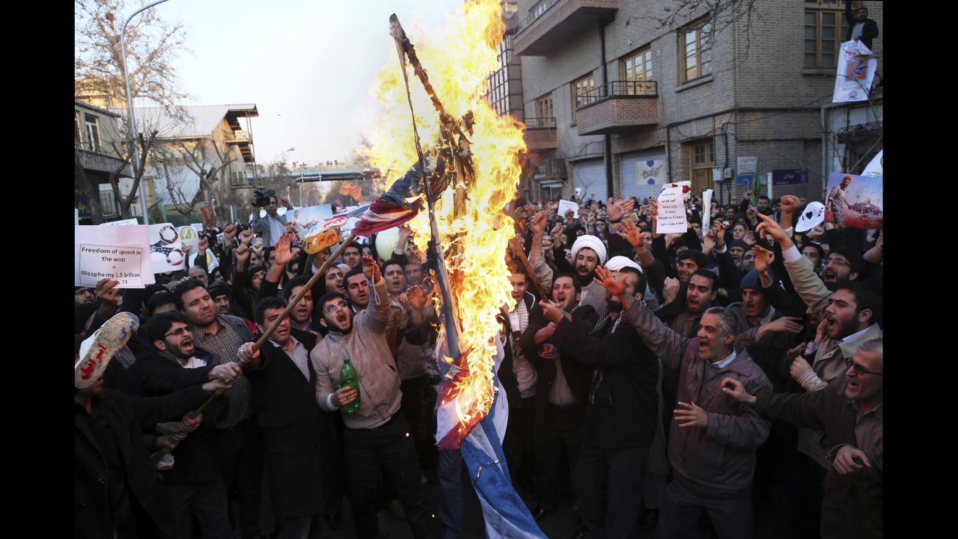 Demonstrators burn representations of Israeli and U.S. flags during a rally against Charlie Hebdo in front of the French Embassy in Tehran, Iran, on January 19.