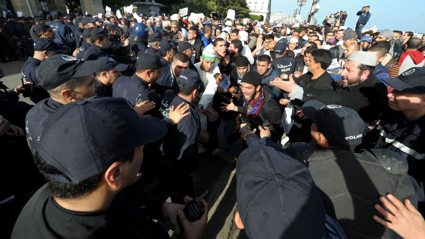 Protesters clash with police officers in Algiers, Algeria, on January 16.