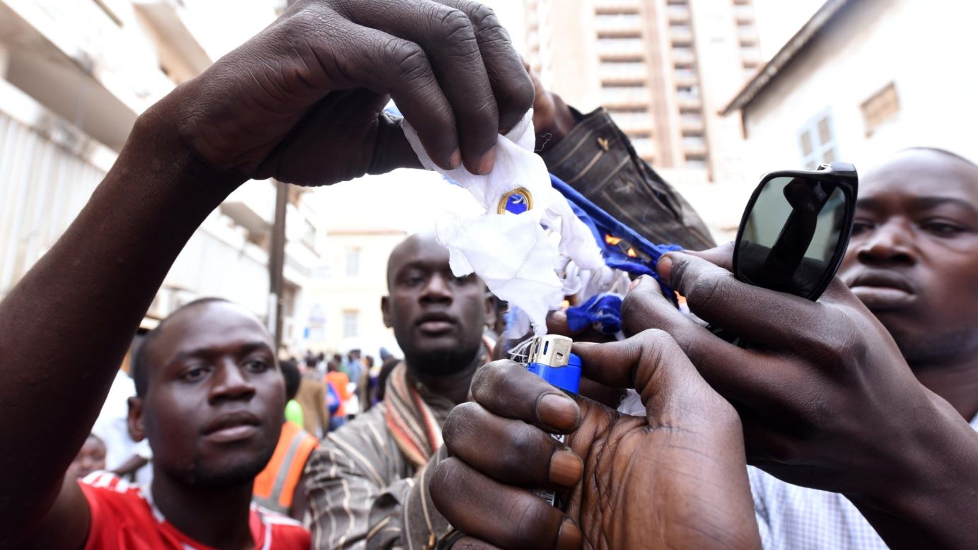 Demonstrators burn a piece of a French flag that they ripped apart during a protest in Dakar, Senegal, on January 16.