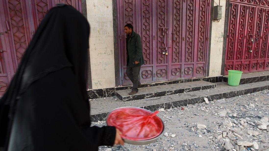 A woman walks past closed shops in Sanaa on January 20.