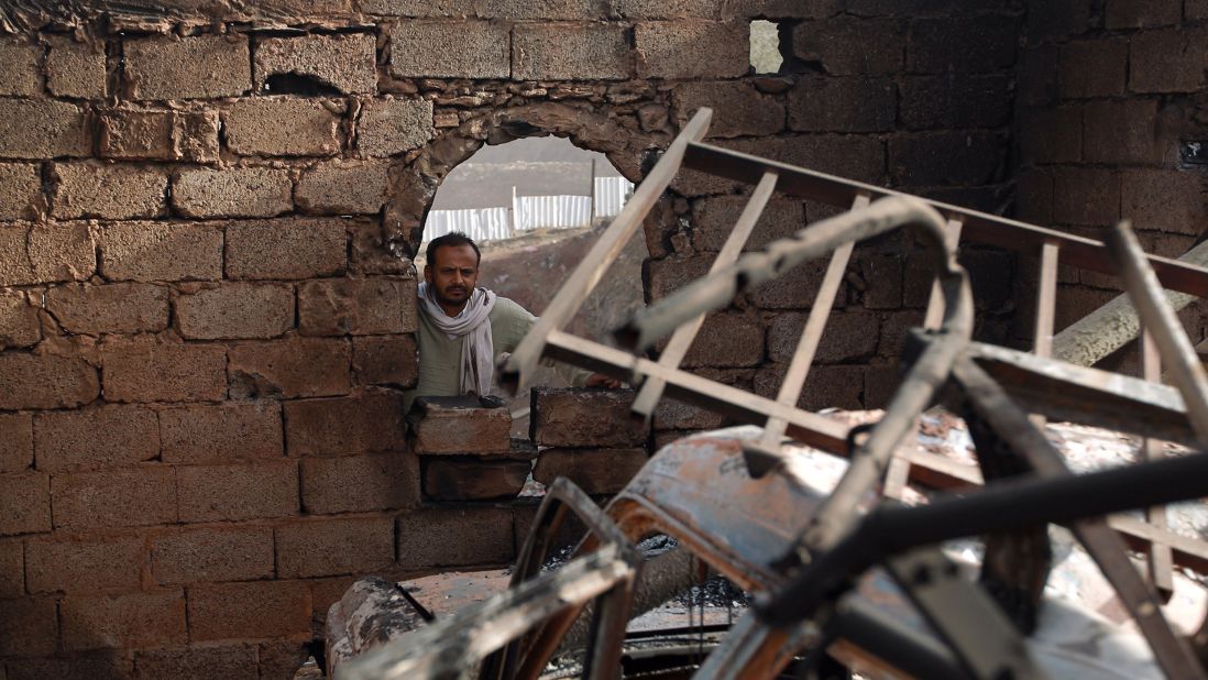 A man surveys his damaged home in Sanaa on January 20.