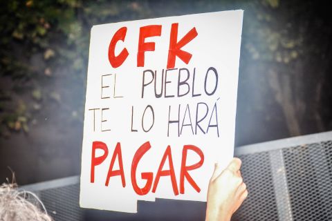 "CFK, the people will make you pay," reads a protester's sign, referring to President Cristina Fernandez de Kirchner. Nisman was set to testify on a report alleging that the President, Foreign Minister Hector Timerman and other officials had covered up Iran's involvement in the bombing of the Argentine Israelite Mutual Association building.