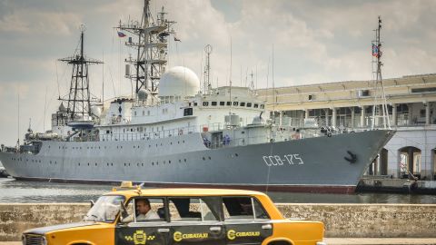 A Soviet-made Lada limousine passes by the Russian warship CCB-175 Viktor Leonov docked in 2014 in Havana.
