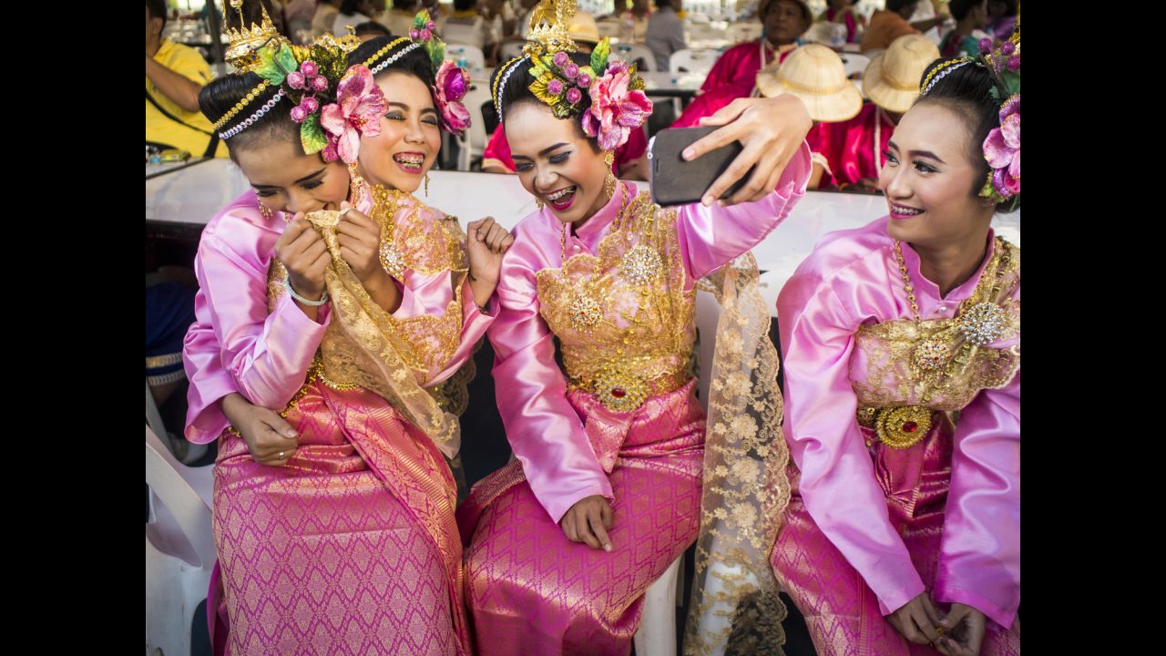 Girls in traditional attire pose for a photo before the Discover Thainess parade in Bangkok, Thailand, on Wednesday, January 14.