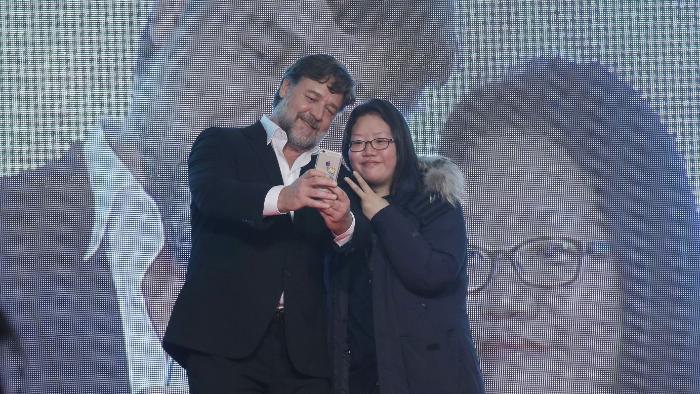 Actor Russell Crowe takes selfies with a fan in Seoul, South Korea, during a red carpet event for "The Water Diviner" on Monday, January 19. Crowe directed the film.