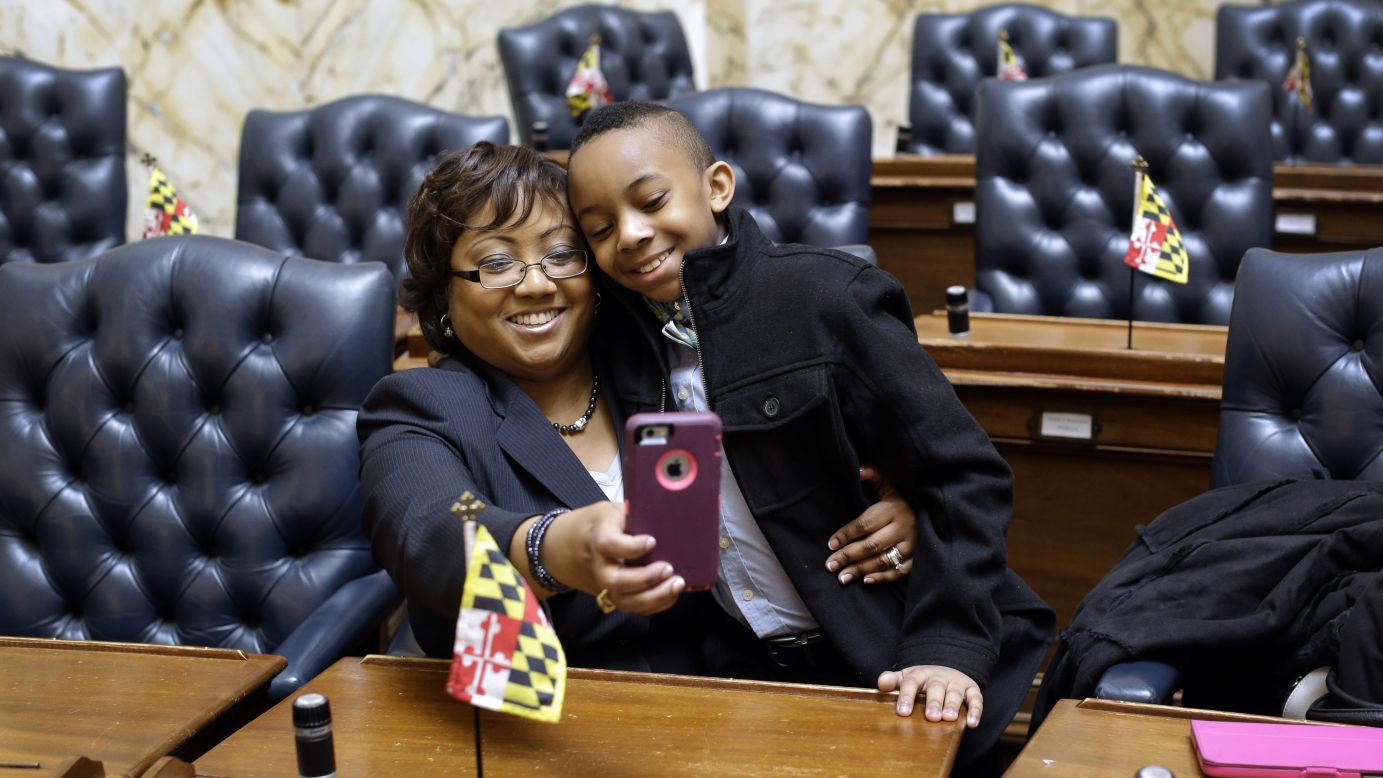 Maryland Rep. Sheree Sample-Hughes gets a selfie with her son Noah as she sits in her seat on the House of Delegates floor Wednesday, January 14, in Annapolis, Maryland. It was the first day of the legislative session.