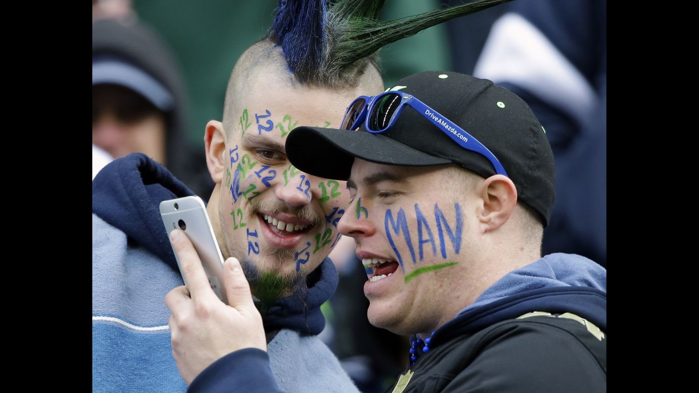 Fans of the NFL's Seattle Seahawks -- aka the 12th Man -- take photos together before the NFC Championship on Sunday, January 18. The Seahawks defeated the Green Bay Packers to advance to the Super Bowl for the second straight season.