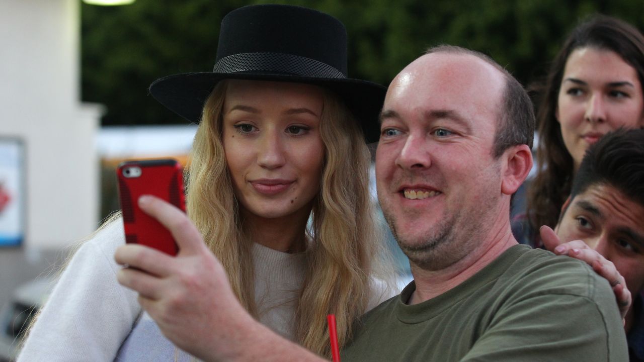Rapper Iggy Azalea takes selfies with fans after stopping for gas in Los Angeles on Friday, January 16.