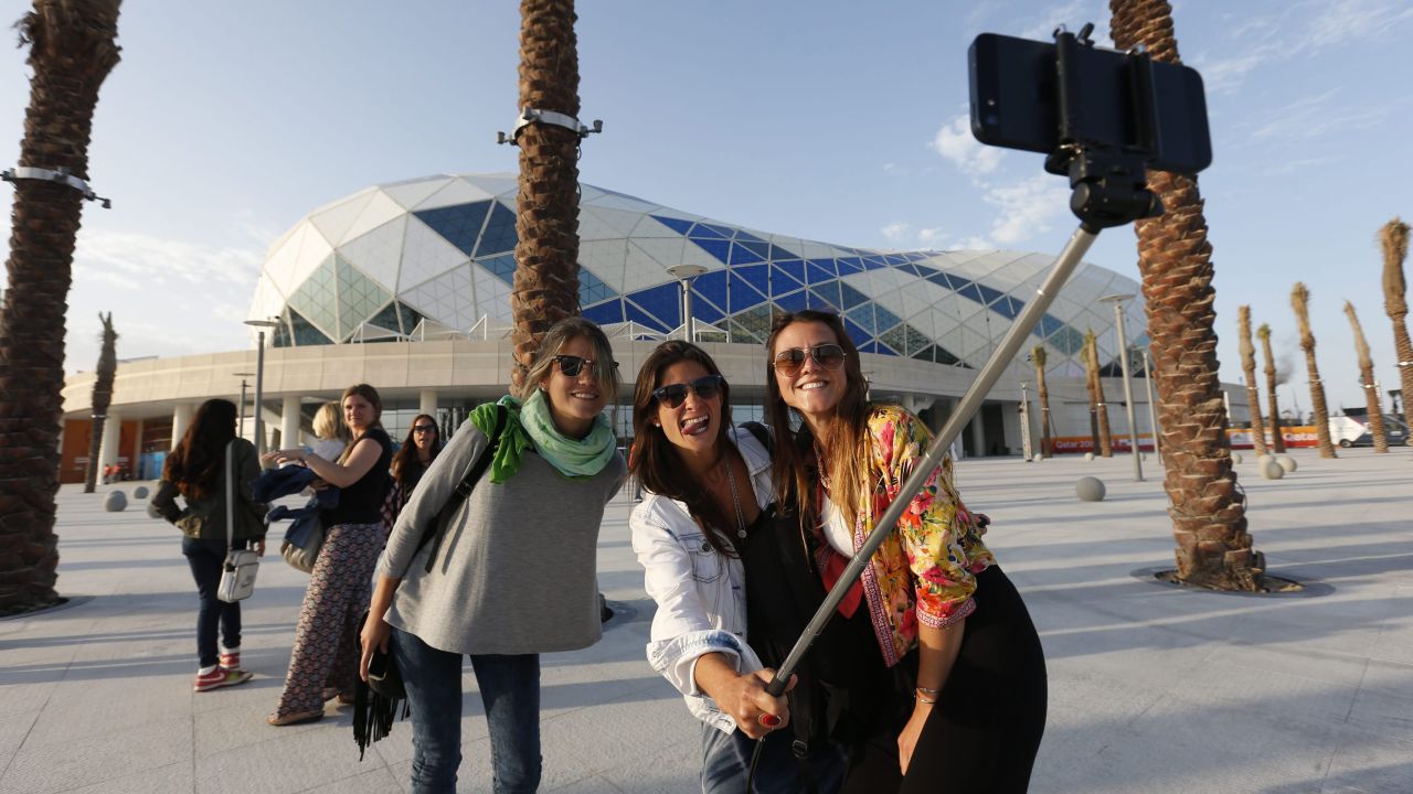 People take a picture Thursday, January 15, in front of the Lusail Multipurpose Hall, an arena near Doha, Qatar, that's hosting games for the Handball World Championship.