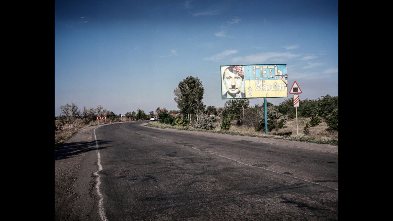 A billboard with a picture of Russian President Vladimir Putin as Hitler and the words "Get out from Ukraine," is seen on the road from Mykolaiv to Kherson in July 2014.