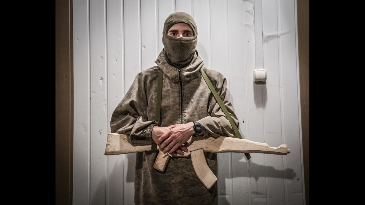 A fighter holds a wooden gun during training at a Right Sector training camp in the Carpathian Mountains.