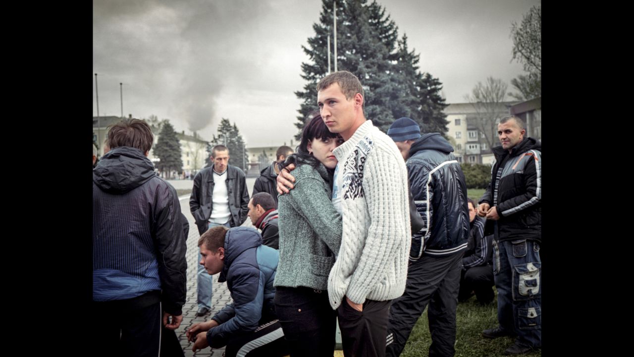 A couple stand with a pro-separatist "civil self-defense" group of locals. They were unarmed and kept vigil by the administrative building in Yenakiieve, the birthplace of ousted President Viktor Yanukovych.<br />