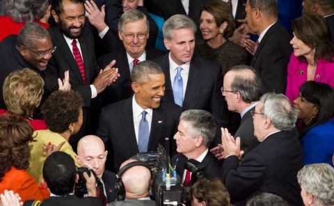 Obama greets members of Congress as he arrives at the House.