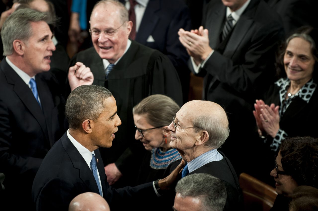 Obama, speaks with Supreme Court Justice Stephen Breyer as he enters the House.